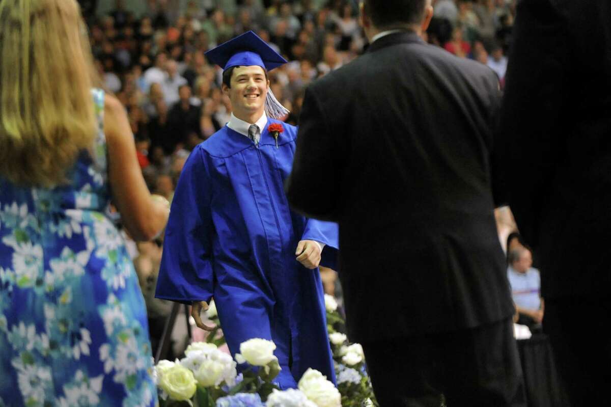 Graduate Brendon Closs, center, strides across the stage to receive his diploma during the Shaker High commencement ceremony on Saturday, June 27, 2015, at UAlbany in Albany, N.Y. (Cindy Schultz / Times Union)