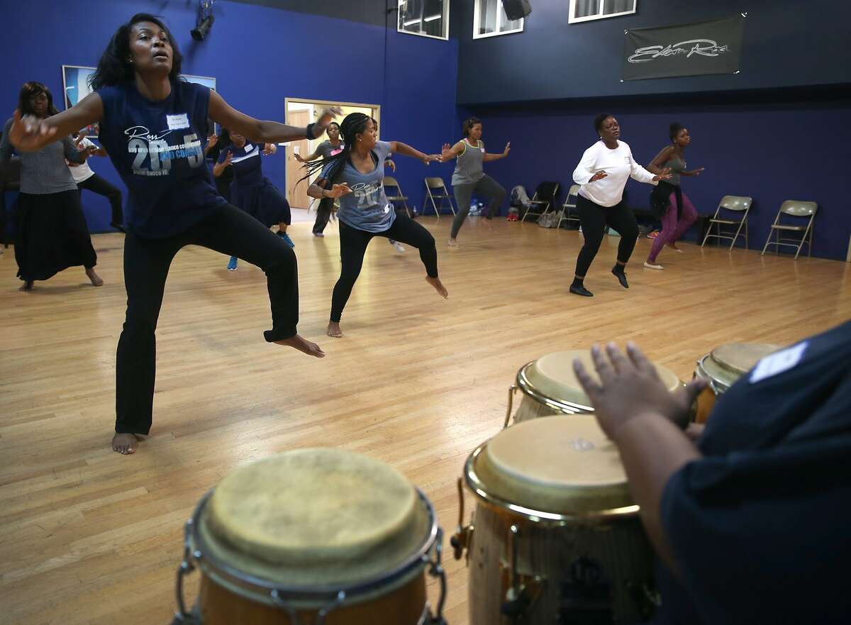 Tecsia Evans (left) teaches a class for Ross Dance, a faith-based dance company, during the Praise dance convention and workshop in Oakland, Calif. on Saturday, June 27, 2015.
