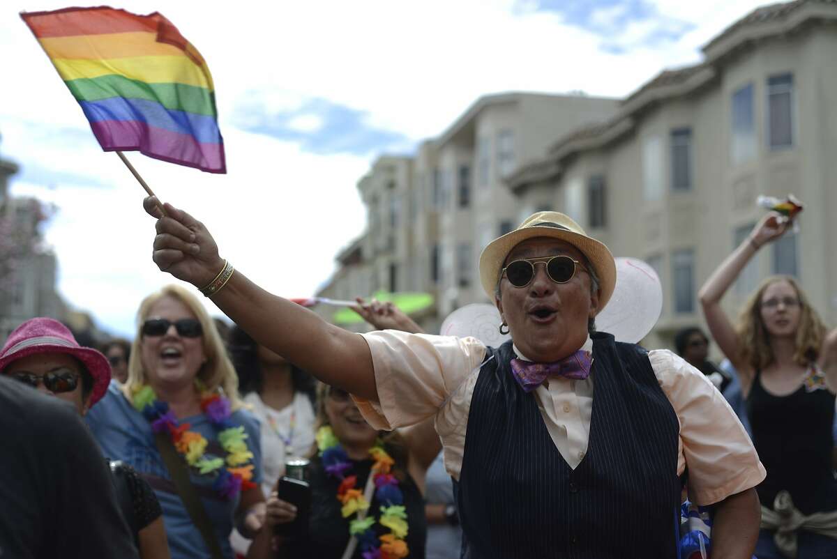 Supporters of gay pride and the Dyke March walk on 16th street in San Francisco, California, on Saturday, June 27, 2015.