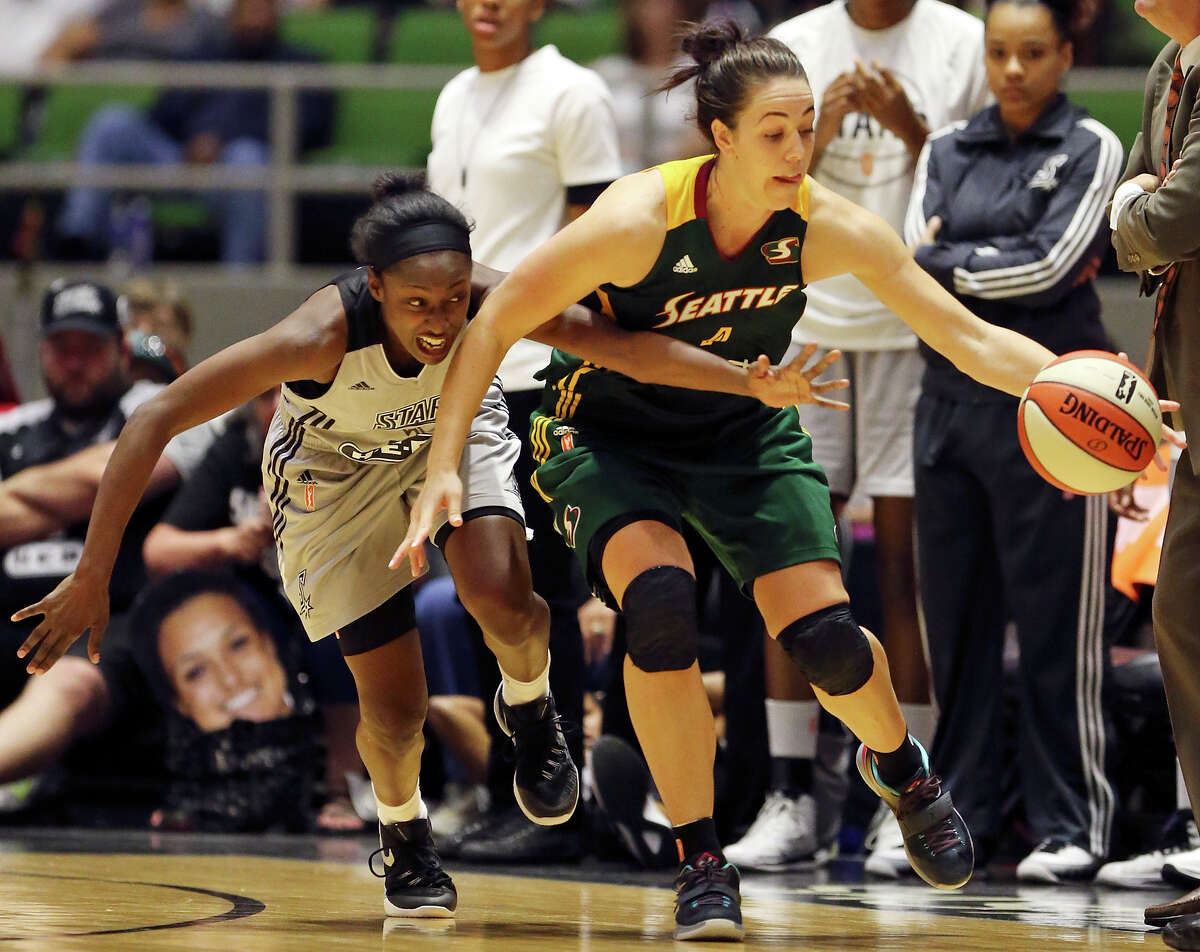 San Antonio Stars’ Kalana Greene and Seattle Storm’s Jenna O’Hea chase after a loose ball during second half action Saturday June 27, 2015 at the Freeman Coliseum. The Stars won 73-71.