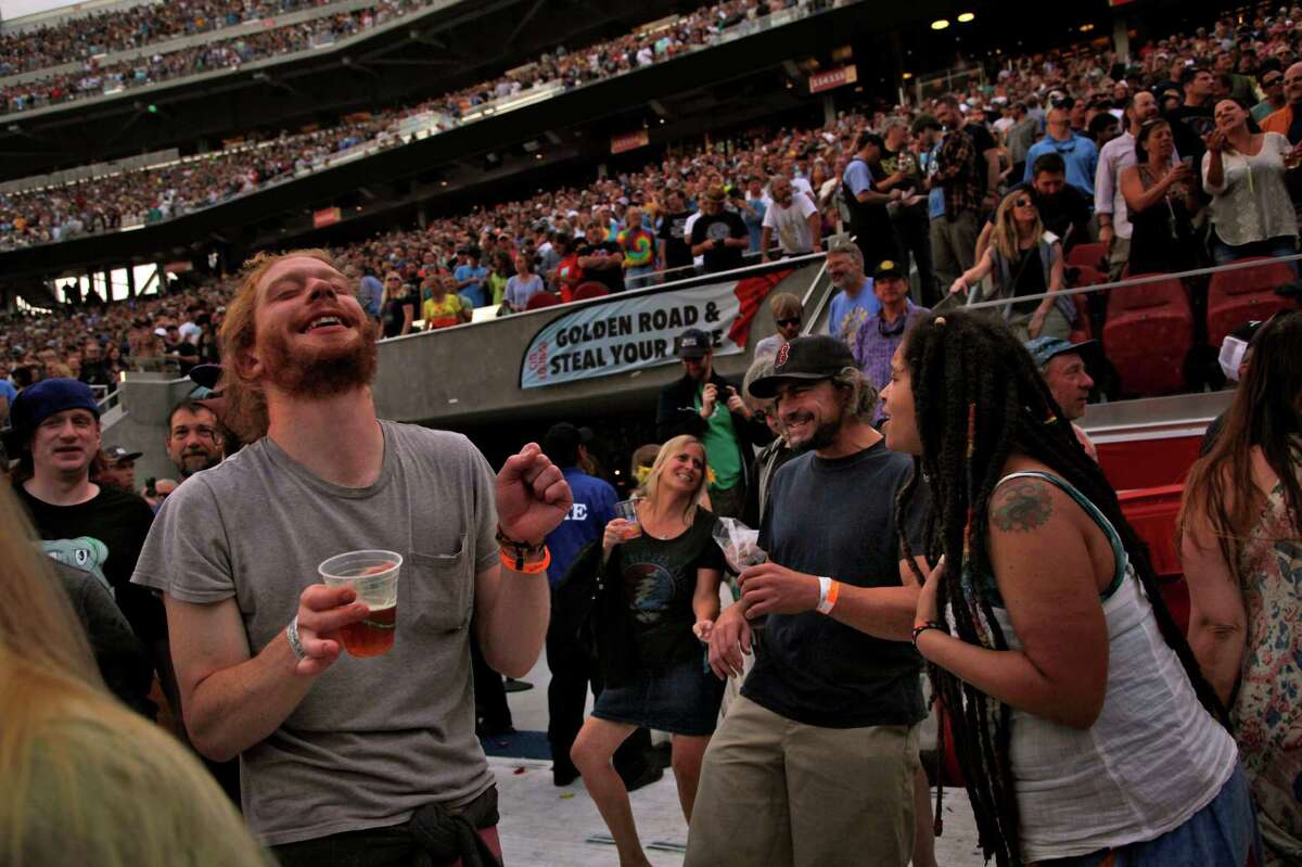 Grateful Dead fans dance during the first show of the band’s “Fare Thee Well” tour, which concludes Sunday in Chicago.
