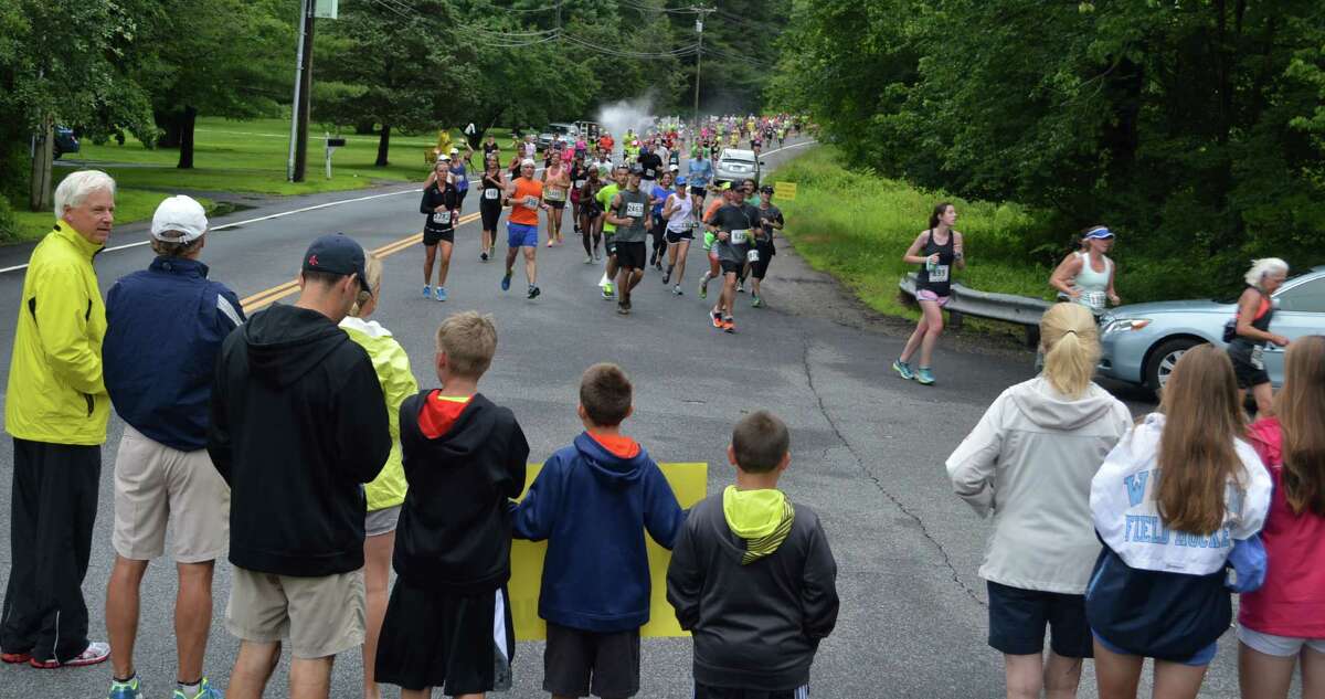 Crowds gathered at New Creek and Greens Farms roads to cheer on the racers Sunday morning in the Fairfield Half Marathon as they ran the Greens Farms section of the course.