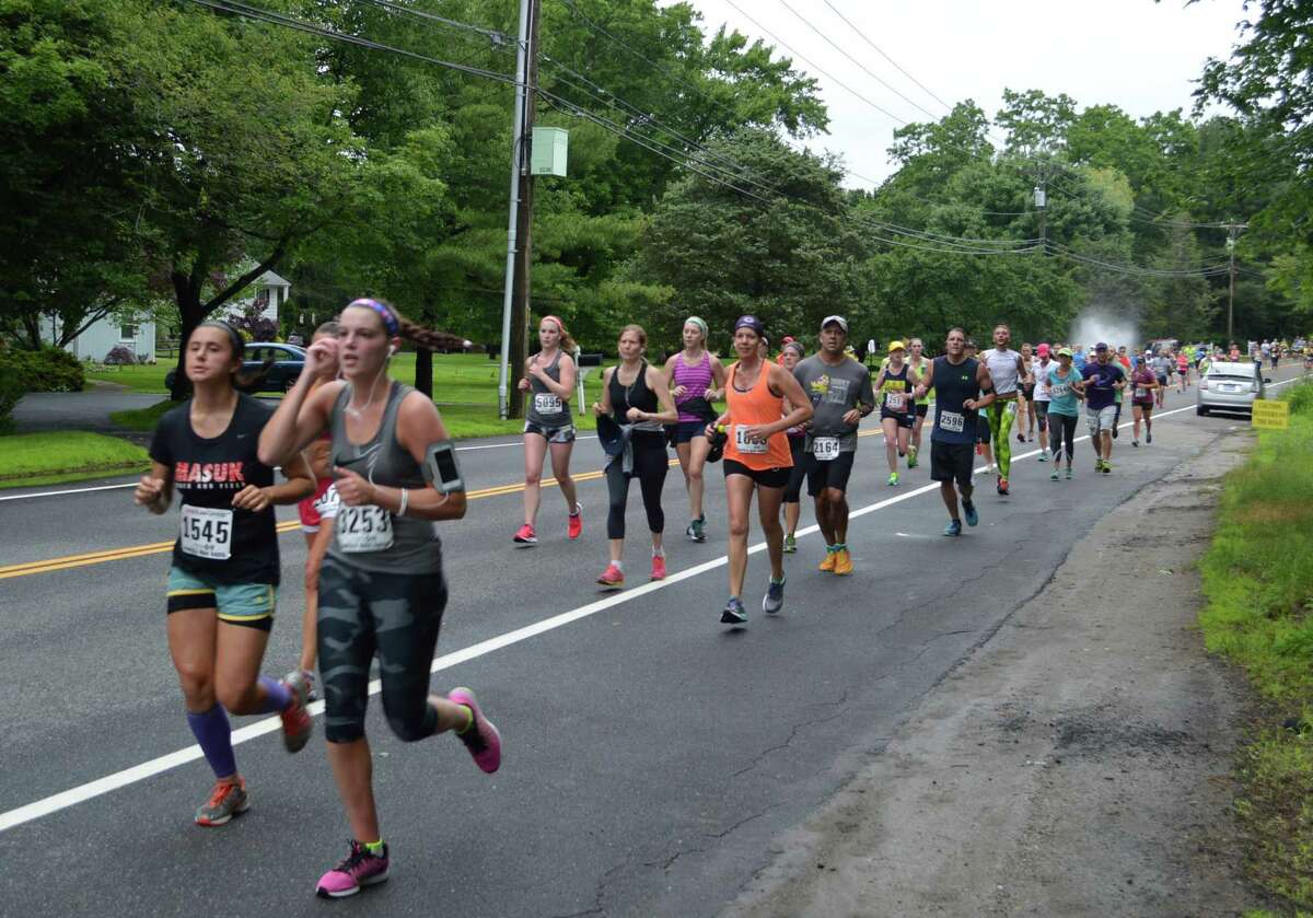 Some of the several thousand runners in the Fairfield Half Marathon as they hit the 3-mile Westport section of the course Sunday morning.