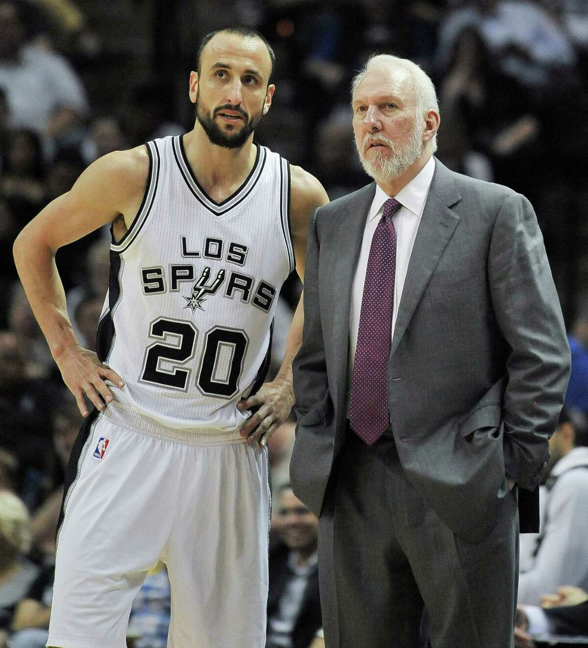 San Antonio Spurs coach Gregg Popovich, right, talks with guard Manu Ginobili, of Argentina, during the second half against the Denver Nuggets on April 3, 2015, in San Antonio.