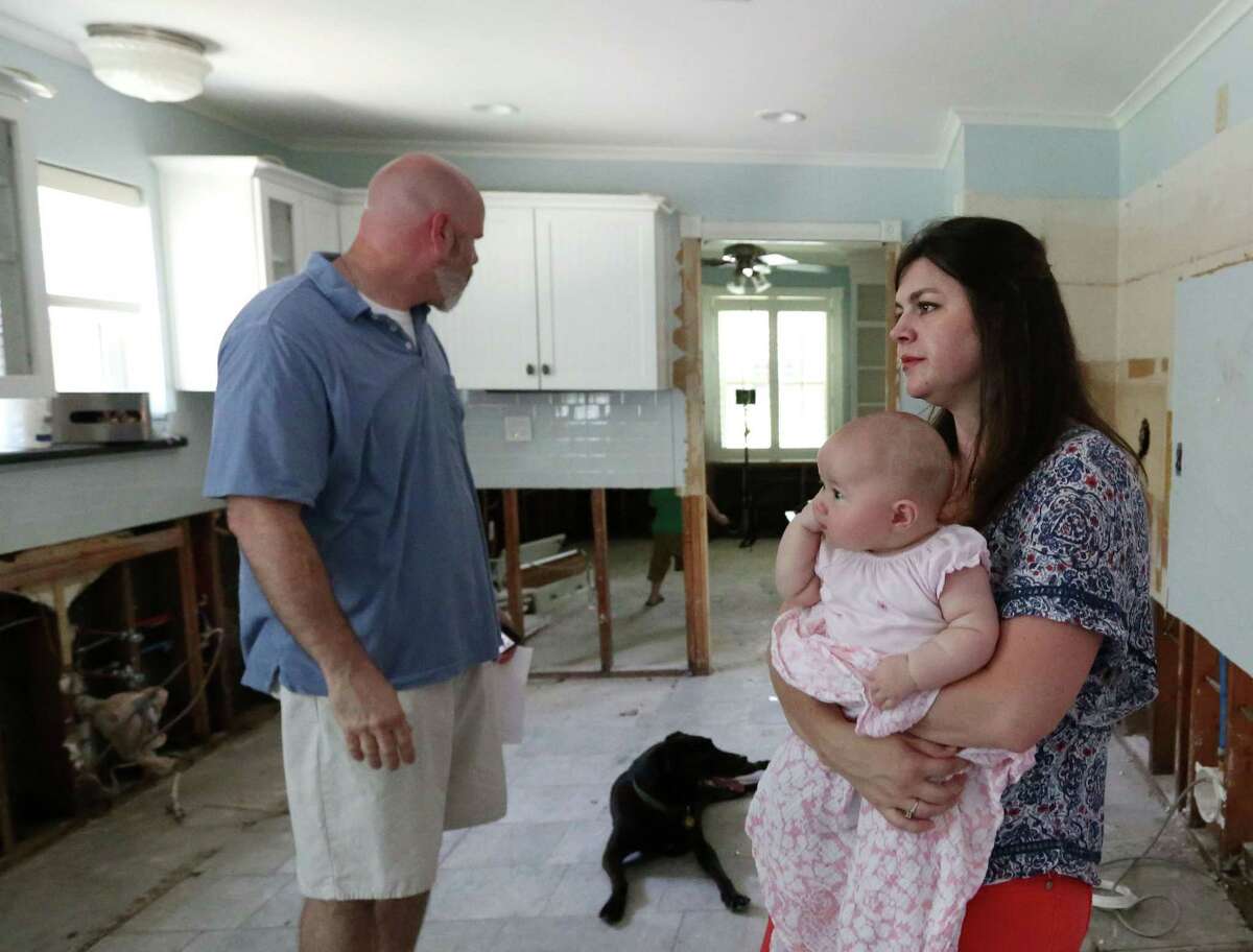 Rob and Emily Ervin, with four-month-old daughter Tessa, don't yet know if they will be required to raise their home in order to make repairs.﻿