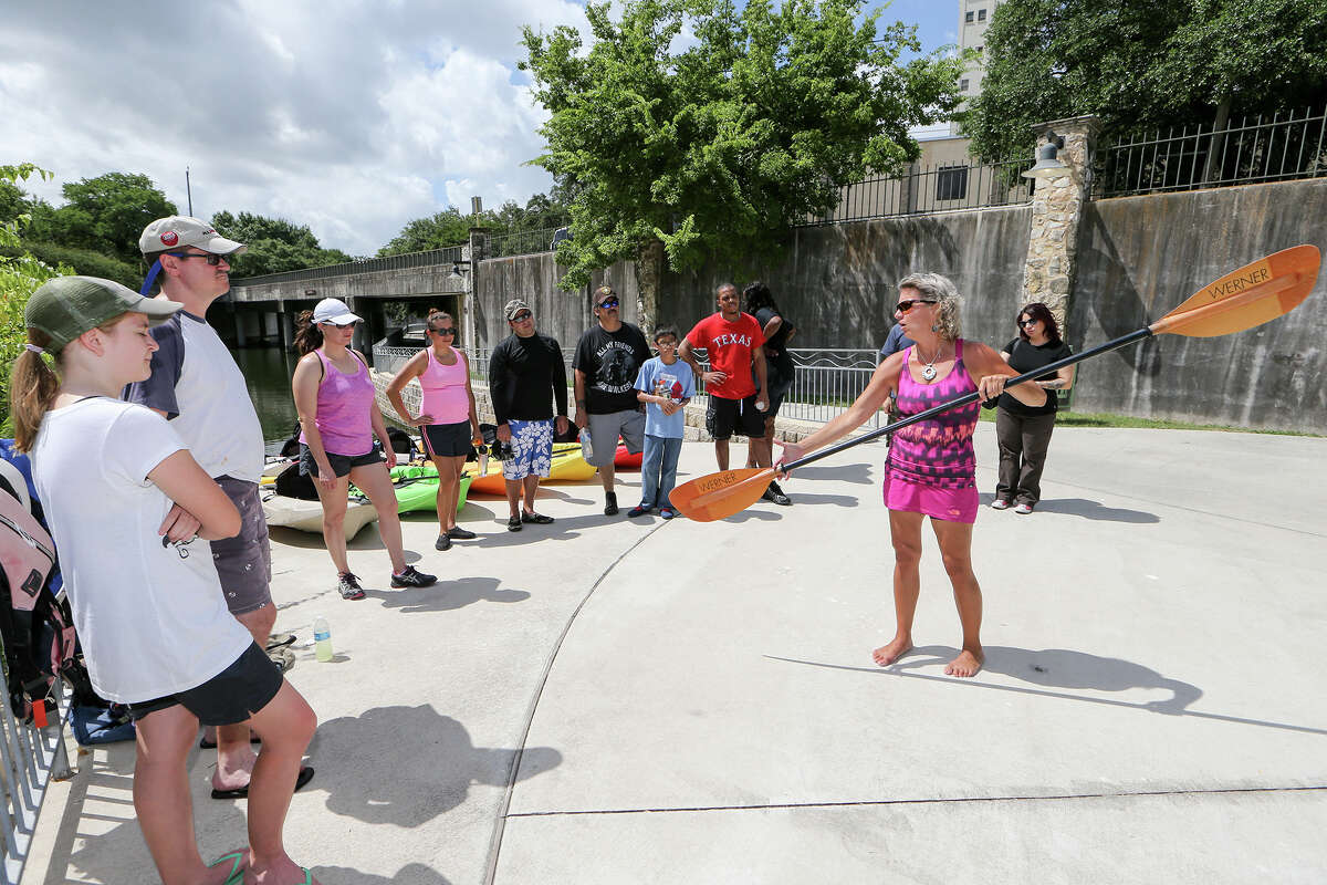 Stacey Banta, a certified kayak instructor with Texas Pack and Paddle, teaches proper handling of a paddle for a guided tour on the San Antonio River. The number of kayakers, paddle boarders and canoeists on the river and San Pedro Creek has been rising.