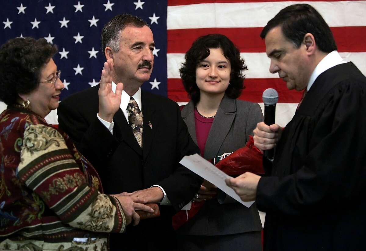 U.S. Rep. Ciro Rodriguez, D-Texas, is administered the oath of office by U.S. District Judge Orlando Garcia, in the company of his wife, Carolina Pena, left, and daughter, Xochil, Monday, Jan. 1, 2007, at the Harlandale Civic Center in San Antonio.