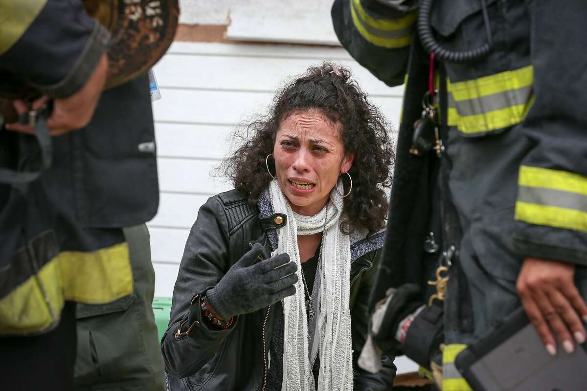 A woman who wished to not be identified, identifies her dog who was found dead in the house on Plymouth Street, which also affected both neighboring houses in San Francisco on Monday, June 29, 2015.