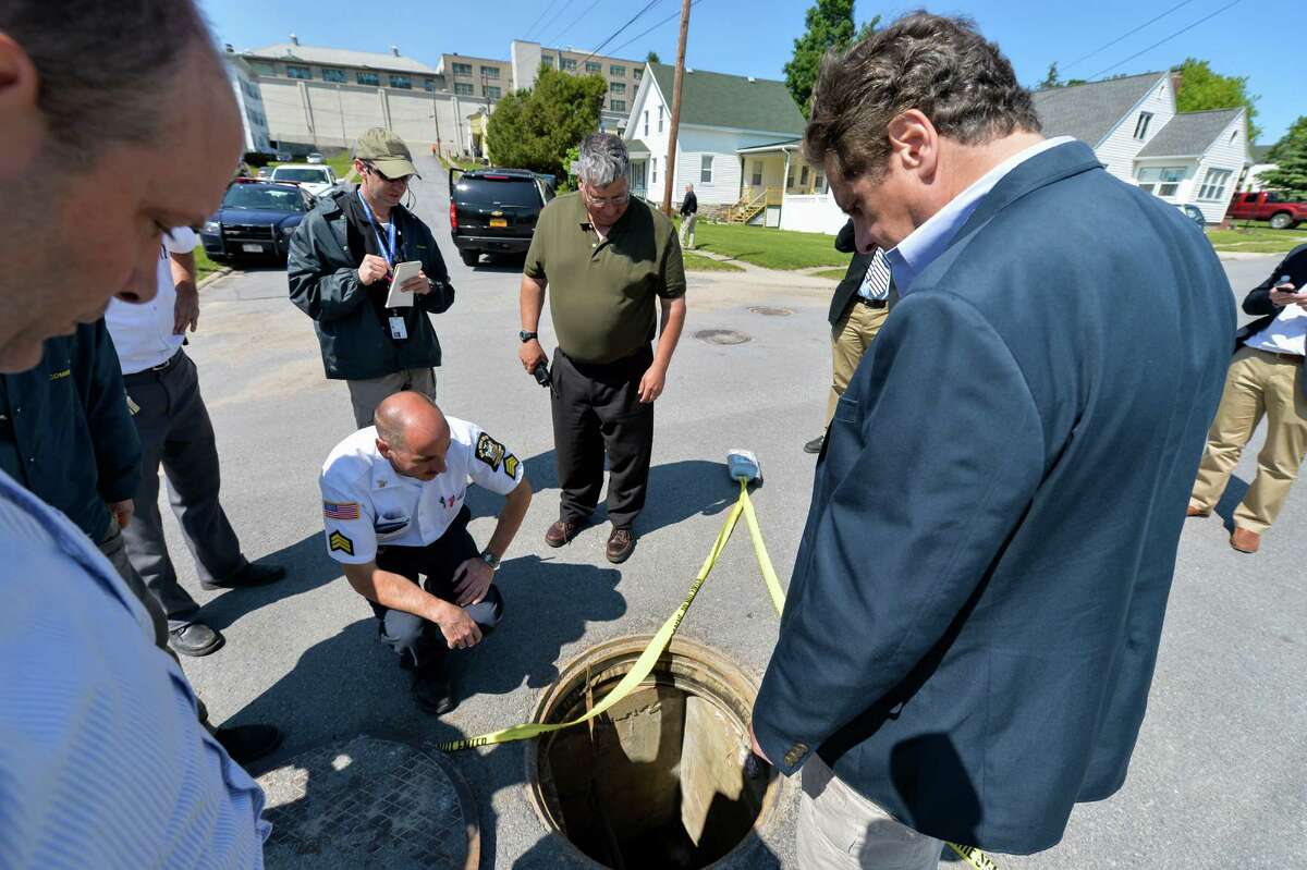 DANNERMORA, NY - JUNE 6: In this handout from the New York State Governor's Office, Superintendent Steven Racette, center, stands over the manhole as New York Gov. Andrew Cuomo, right, is shown where two convicted murderers escaped from the Clinton Correctional Facility June 6, 2014 in Dannemora, New York. Police are on a manhunt for Richard Matt, 48, and David Sweat, 34, who escaped from the maximum security prison June 6, 2015 using power tools and going through a manhole. (Photo by Darren McGee/New York State Governor's Office via Getty Images)