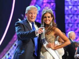 FILE - In this June 16, 2013 file photo, Donald Trump, left, and Miss Connecticut USA Erin Brady pose onstage after Brady won the 2013 Miss USA pageant in Las Vegas, Nev. Univision says it is dropping the Miss USA Pageant and says it will cut all business ties with Donald Trump over comments he made about Mexican immigrants. The network said Thursday, June 25, 2015, it will not air the pageant on July 12, as previously scheduled, and has ended its business relationship with the Miss Universe Organization due to what it called "insulting remarks about Mexican immigrants" by Trump, a part owner. (AP Photo/Jeff Bottari, File)
