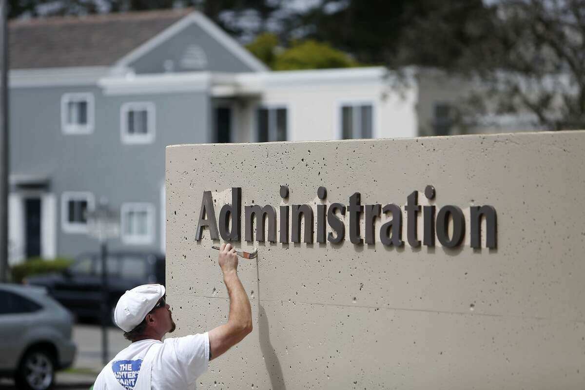Jon Mulry, painter for San Francisco State University, paints the Administration Building at San Francisco State University behind which is seen part of the block Cardenas Avenue at Holloway Avenue on Tuesday, June 30, 2015 in San Francisco, Calif.
