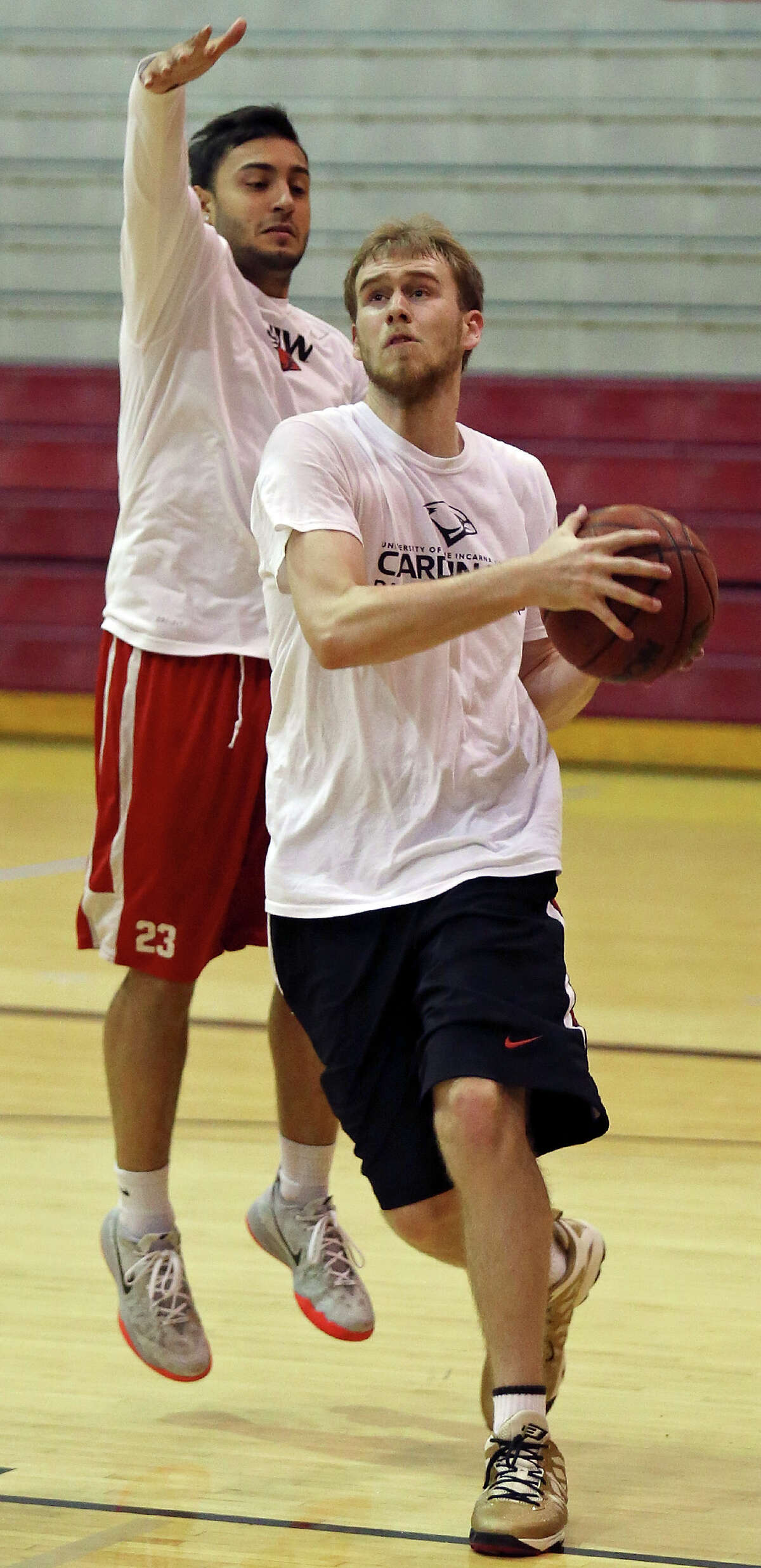 University of the Incarnate Word’s Jorden Kite (right) drives to the basket around University of the Incarnate Word’s Mitchell Badillo during a workout Monday June 29, 2015 at the McDermott Center.