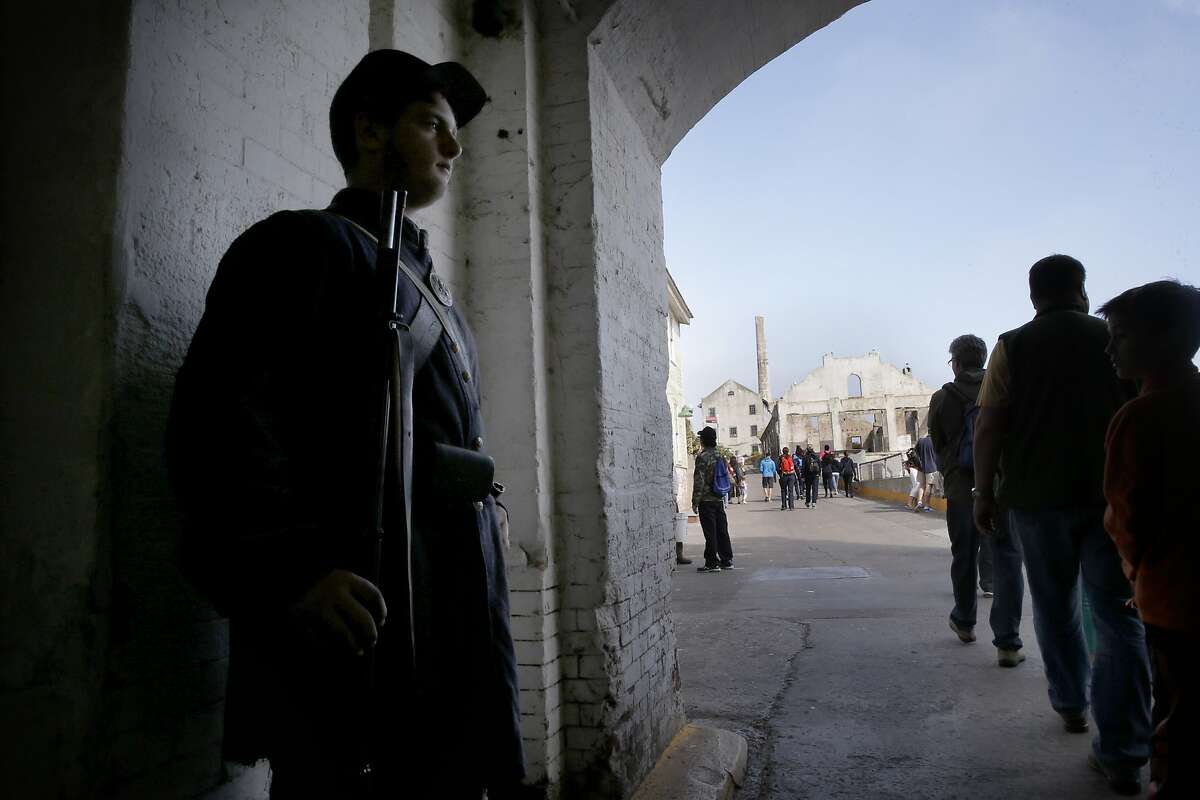 Joshua Putman dressed in Civil War character stands post on the north end of the sally port on Alcatraz Island, as the National Park Service unveils renovations of its Guardhouse Complex on Alcatraz Island, as seen on Wed. July 1, 2015, in San Francisco, Calif.