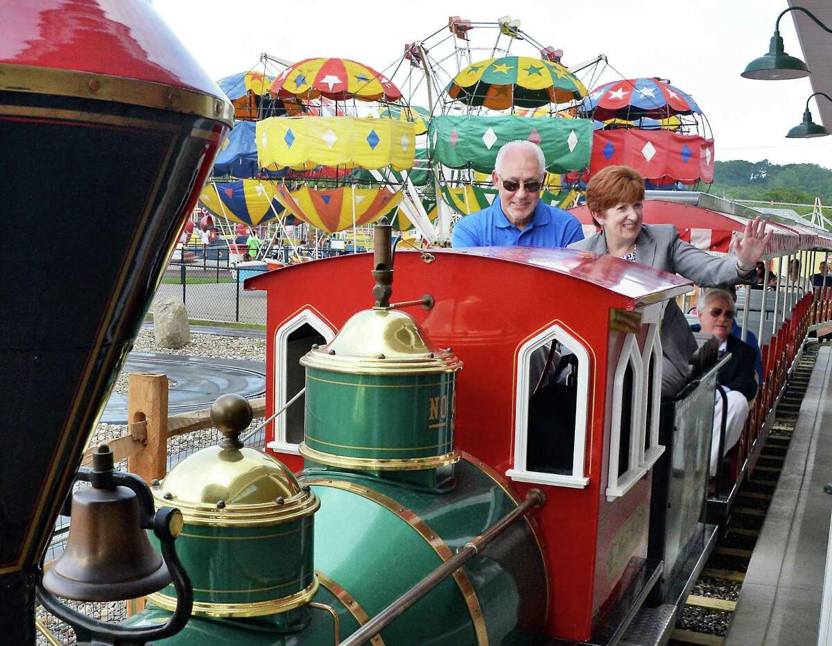 CEO Jeff Sperbers, left, and Mayor Kathy Sheehan ride the Playland train during the Grand opening of Huck Finn's Playland Wednesday July 1, 2015, Albany, NY. (John Carl D'Annibale / Times Union)