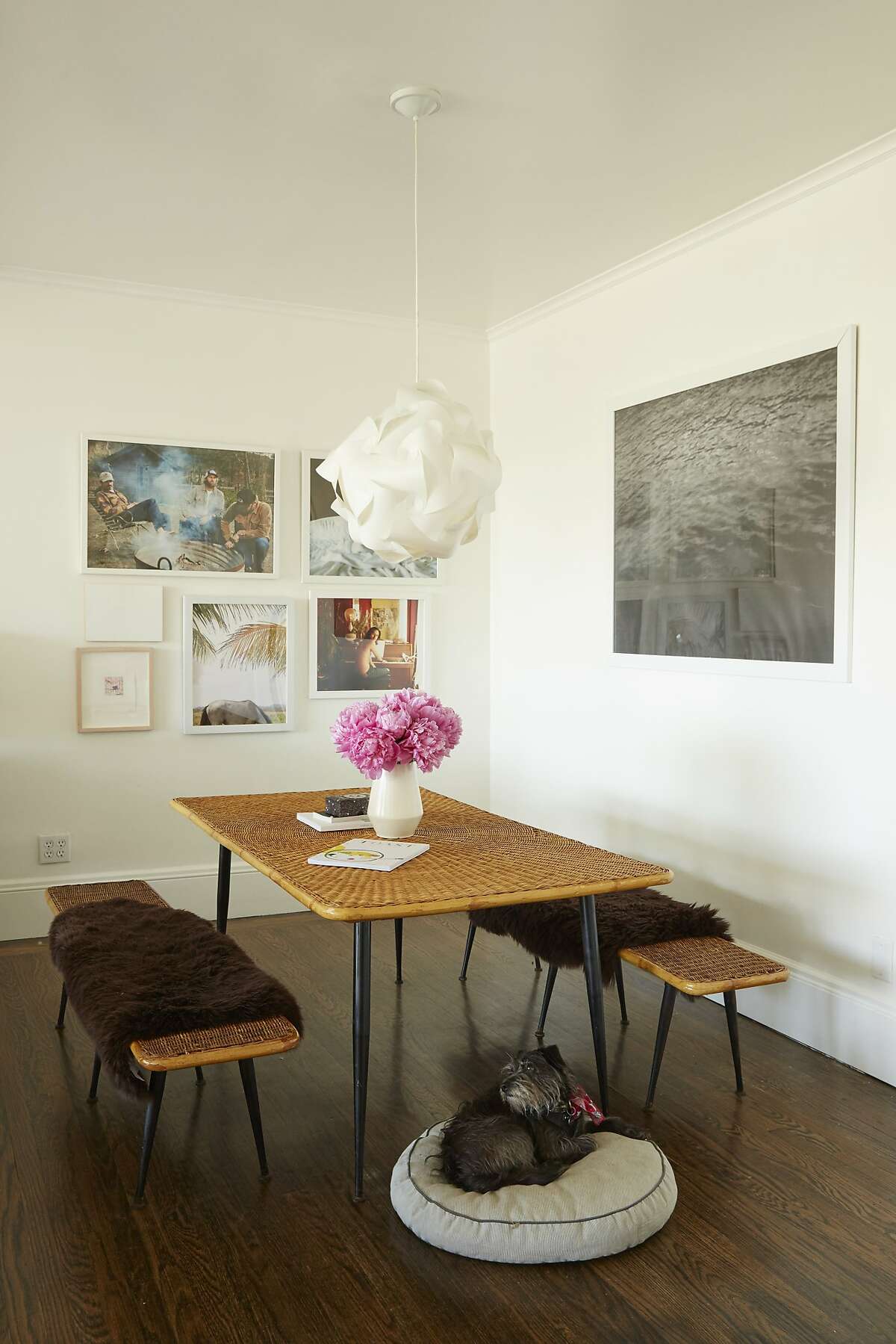The dining room exhibits Gowdy?•s penchant for texture, where the rattan-topped table and benches from Stuff are topped with sheepskins. The framed art on the walls includes works by friends, as well as a large-scale oceanic poster she picked up at the Whitney Museum years ago.