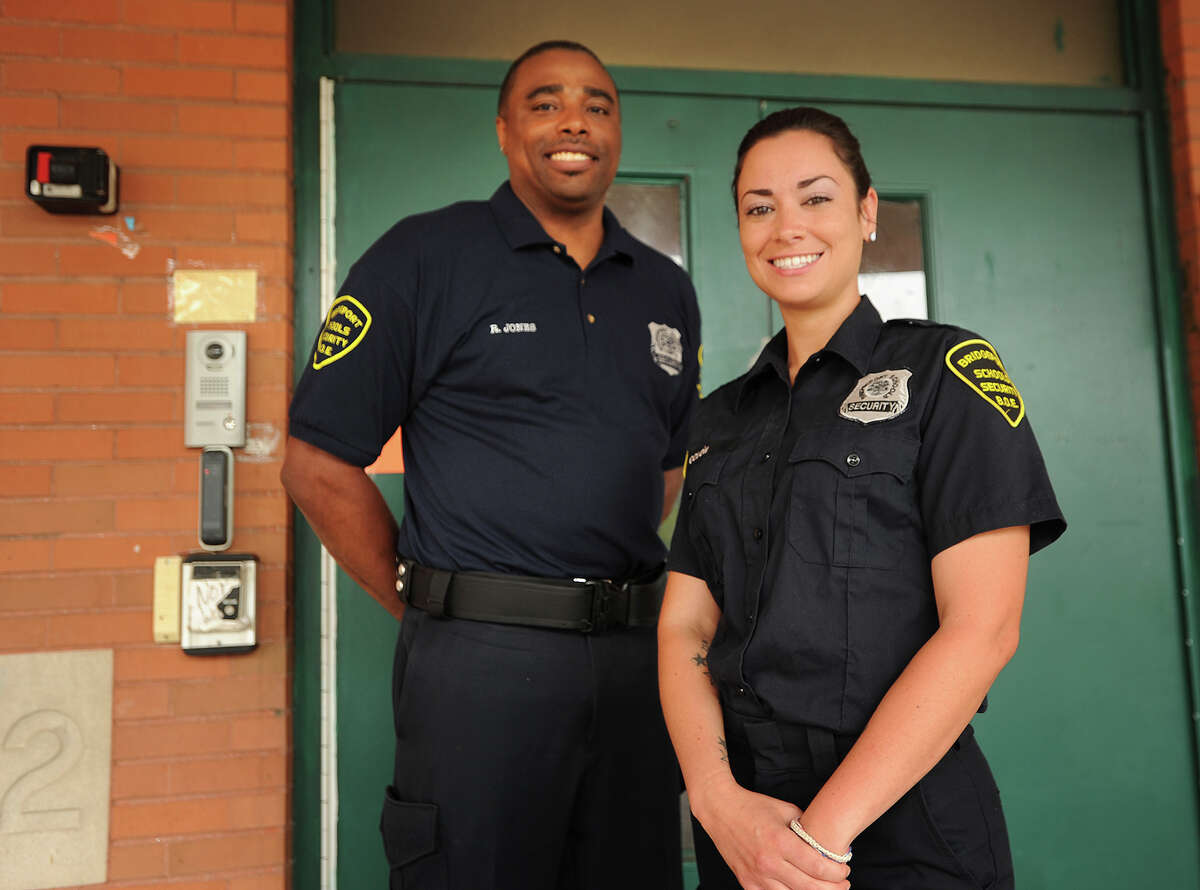 School security officers Rondell Jones, left, and Nicole Colon outside Luis Munoz Marin School in Bridgeport on Wednesday. There was a large drop in the number of arrests in city schools, which police say is partly due to better training and a link to outside services.