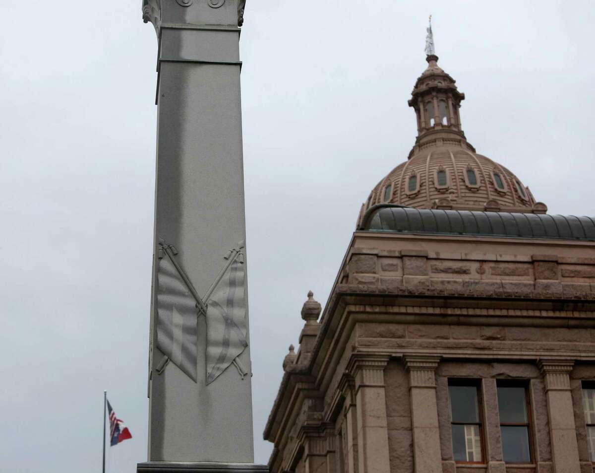 The Confederate State of America Flags are etched on the Hood's Texas Brigade, erected 1910 by surviving comrades and friends, on the Texas State Capitol Grounds Tuesday, June 30, 2015, in Austin, Texas. A gray granite shaft, with hand-carved quotes by President Jefferson Davis, General Robert E. Lee, and others, is topped by the bronze figure of a Confederate soldier. The monument stands as a memorial to the members of John B. Hood's Texas Brigade Army of Northern Virginia.