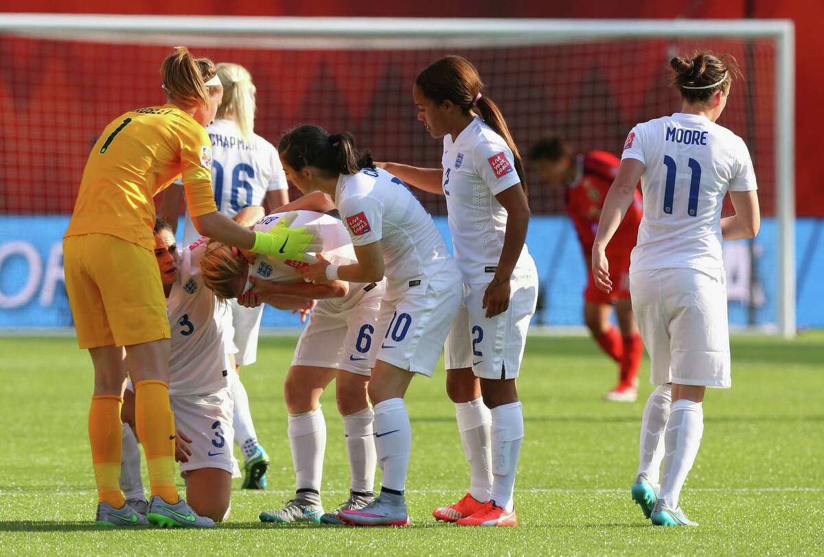 EDMONTON, AB - JULY 01: Laura Bassett of England is comforted by team mates after the FIFA Women's World Cup Semi Final match between Japan and England at the Commonwealth Stadium on July 1, 2015 in Edmonton, Canada. (Photo by Ronald Martinez/Getty Images) ORG XMIT: 528453363