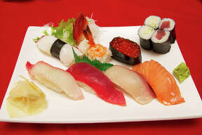 A sushi mix of snapper, tuna, yellowtail, smoked salmon, octopus, shrimp, salmon roe, cucumber roll and tuna roll