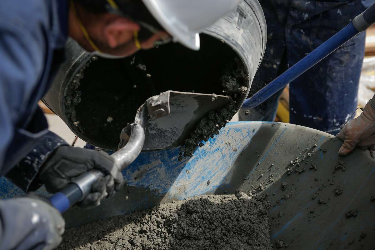 Students make concrete in the "building and construction trades lab" at O'connell High School in San Francisco, California, on Thursday, July 2, 2015. In the course, students participate in the construction of a tiny home and nearby compost bins.