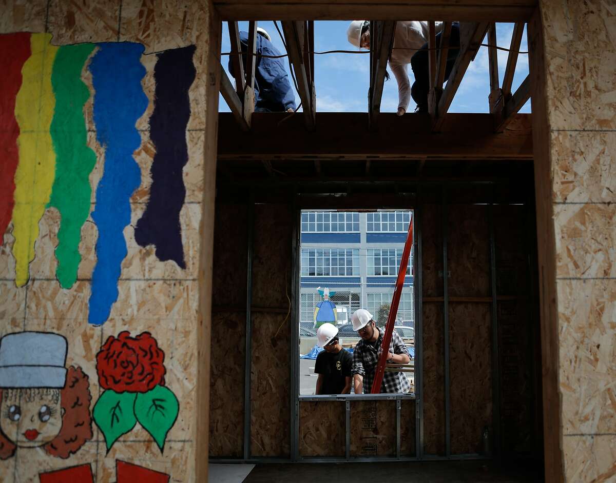 Students Rivandy Junus (top left), Kelly Li (top right), Adrian Andrade (bottom left) and David Jarillo (bottom right) work on the construction of a tiny house during the "building and construction trades lab" at O'connell High School in San Francisco, California, on Thursday, July 2, 2015. The course is taught by Chris Wood.