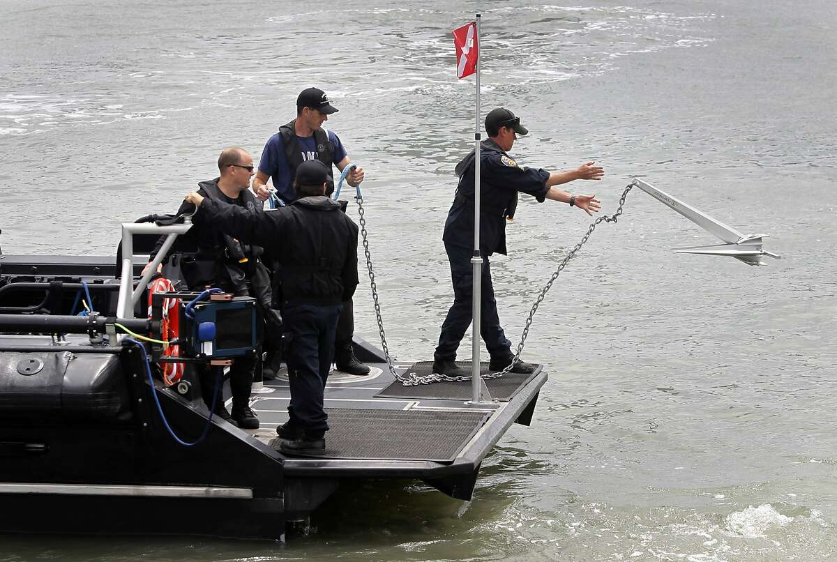 A police department dive team drops anchor before searching for evidence off of Pier 14 in San Francisco, Calif. on Thursday, July 2, 2015 after a woman was shot and killed walking on the pier with her father yesterday afternoon.