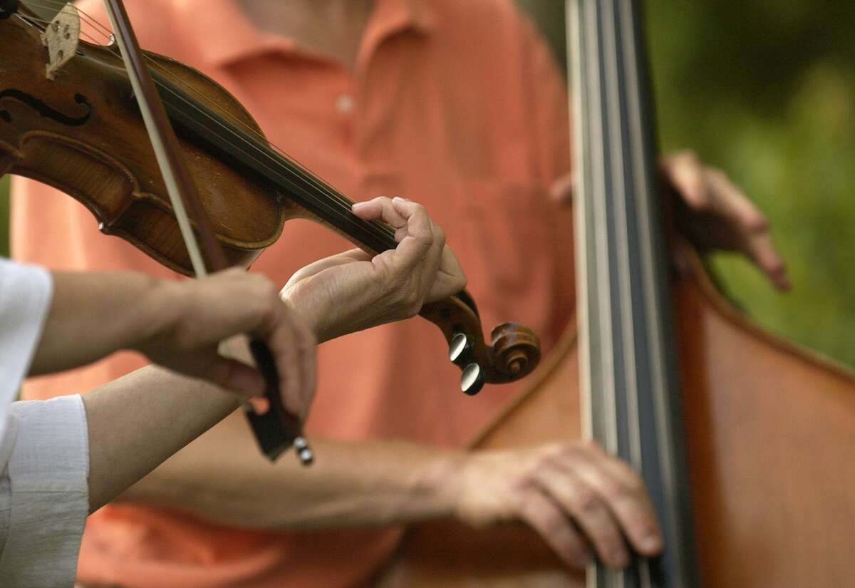 A bass player and a fiddler rehearse at the annual Roxbury Pickin' & Fiddlin' Contest. This year's contest will be Saturday, July 11.