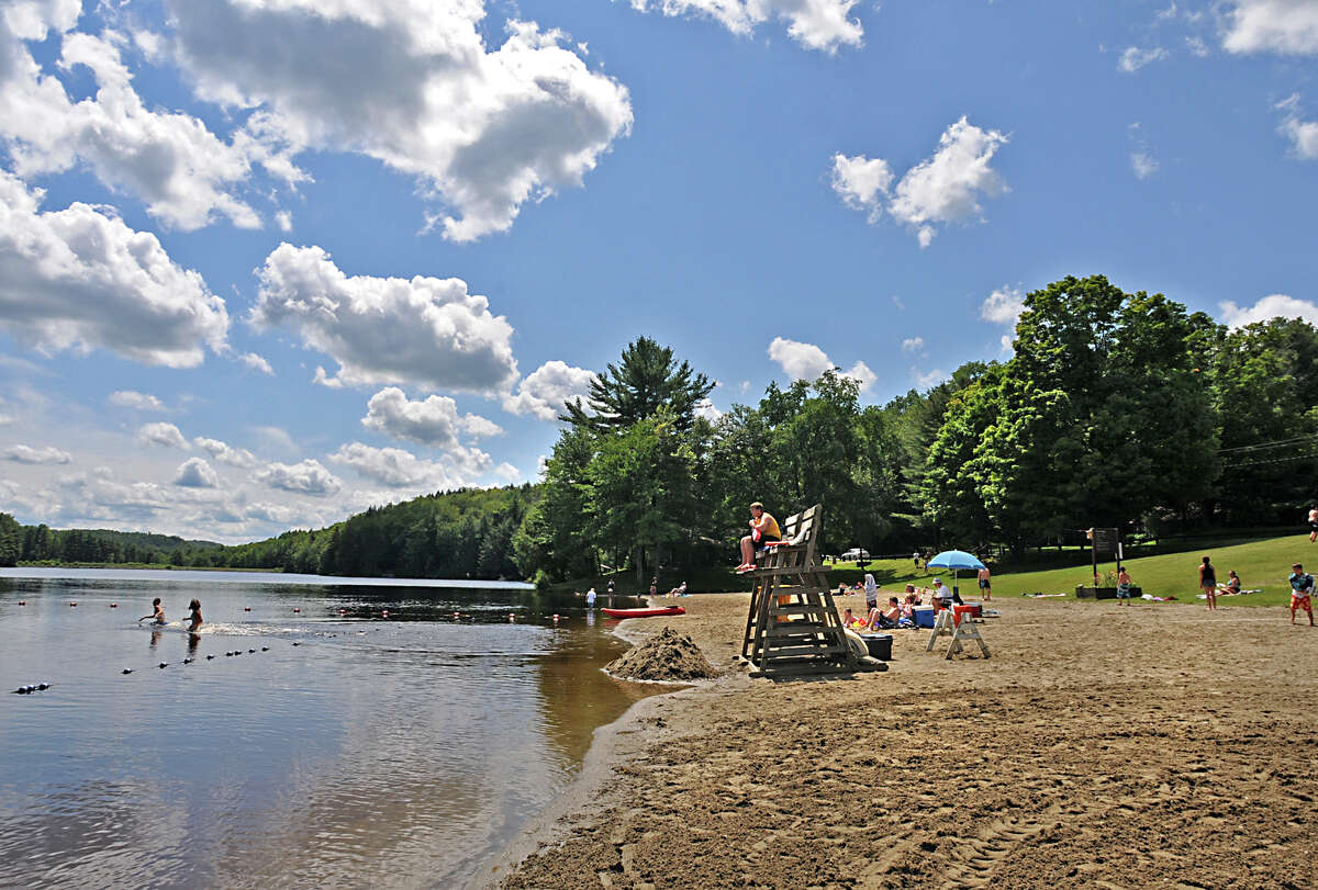 A small crowd of people enjoy the beach on Black River Pond at Cherry Plain State Park in Cherry Plain, NY on Thursday August 6, 2009. A body was found in Cherry Plain Feb. 27, 2022. The woman's death is considered "suspicious," the Rensselaer County Sheriff's Office said.