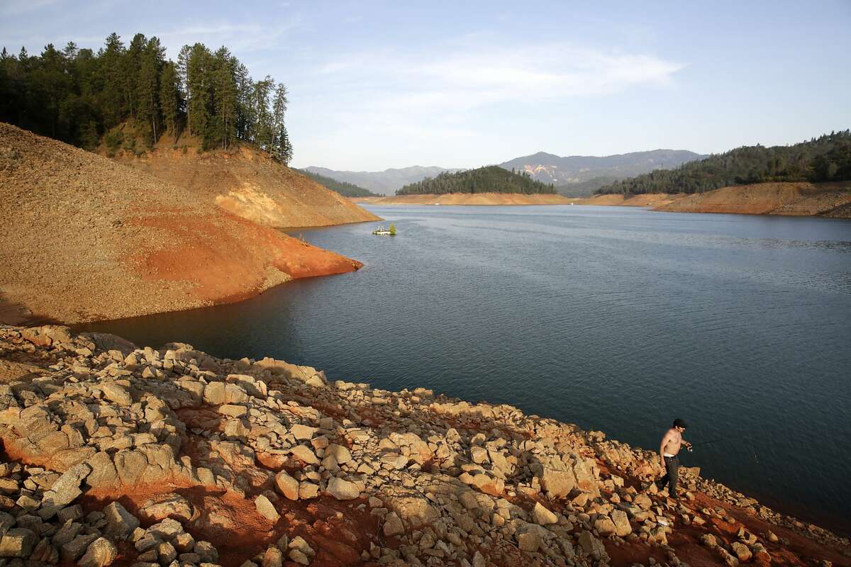 Will Epperson, of Big Bend, CA, carries his fishing pole along the shore of Lake Shasta, CA, on Thursday, July 2, 2015. Mercury levels in bass and catfish in Lake Shasta may be higher than reported in state fishing guidelines, posing a threat to human health.