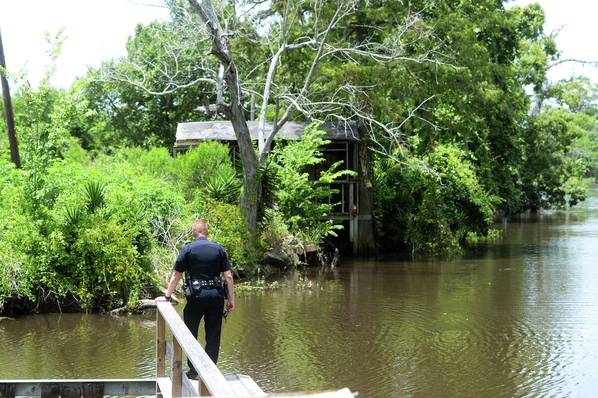 Lt. James Davis looks off the dock at Burkart's Marina on Friday. Tommie Woodward, 28, was attacked and killed by an alligator while swimming in Adams Bayou at Burkart's Marina early Friday morning. The incident was the first fatal attack by an alligator in Texas in about 200 years. Photo taken Friday 7/3/15 Jake Daniels/The Enterprise