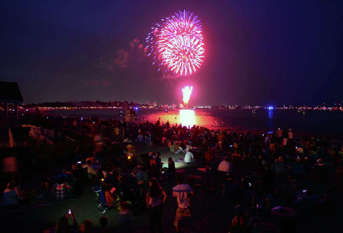 Hundreds of spectators watch the holiday fireworks display at Penfield and Jennings Beaches in Fairfield, Conn., on Friday July 3, 2015.