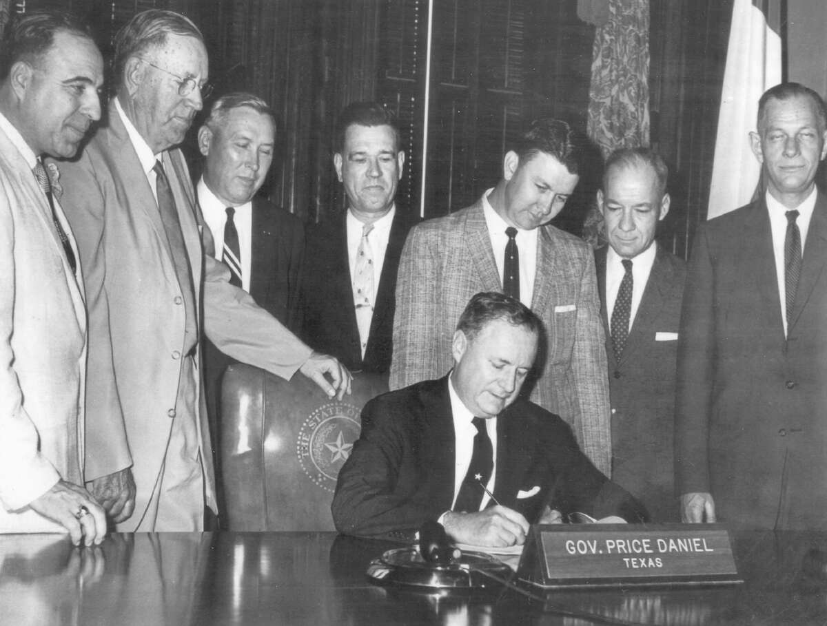 Texas Gov. Price Daniel, seated, signed a bill on April 29, 1959 establishing the South Texas Medical School in San Antonio. In 1972, the school was renamed the University of Texas Health Science Center at San Antonio. Standing left to right are Sen. Henry B. Gonzalez, Sen. R.A. Weinert, Dr. James Hollers, Dr. John Smith Jr., Rep. R.L. Strickland, Dr. John Matthews and Dr. L. Bonham Jones.