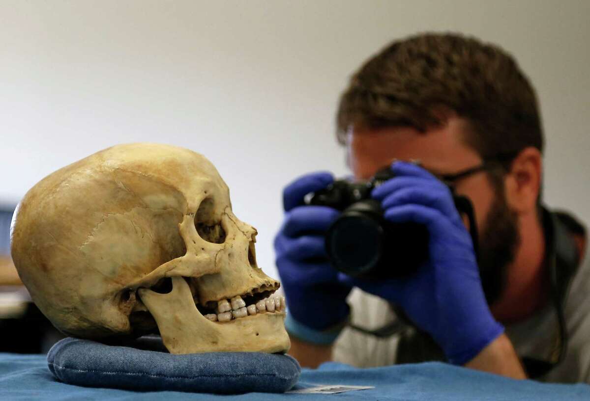 Justin Maiers observes human remains in a lab at Texas State University in San﻿ Marcos where ﻿forensic anthropologists work.