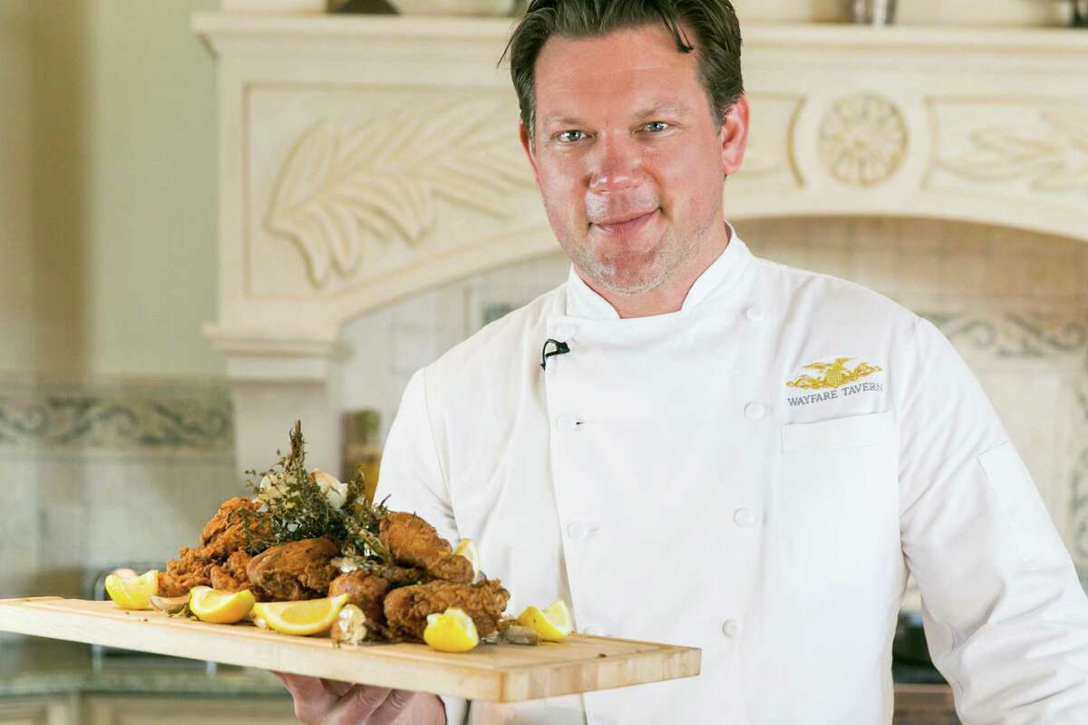 Tyler Florence displays fried chicken complete with fried herbs, garlic and lemon wedges. ﻿