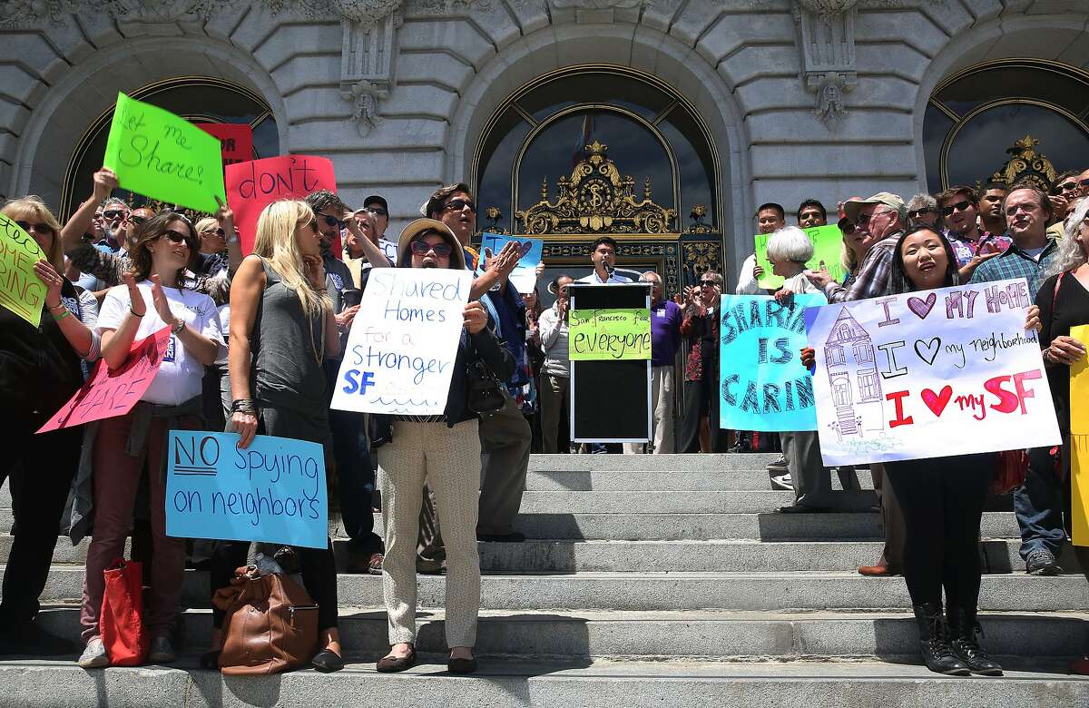 About a hundred protesters representing in a new group called "San Francisco for Everyone" gathered in front of city hall in San Francisco, Calif., on Monday, July 6, 2015. They rallied to protest the expected filing of signatures for a November ballot initiative that would clamp down on home sharing in private homes.