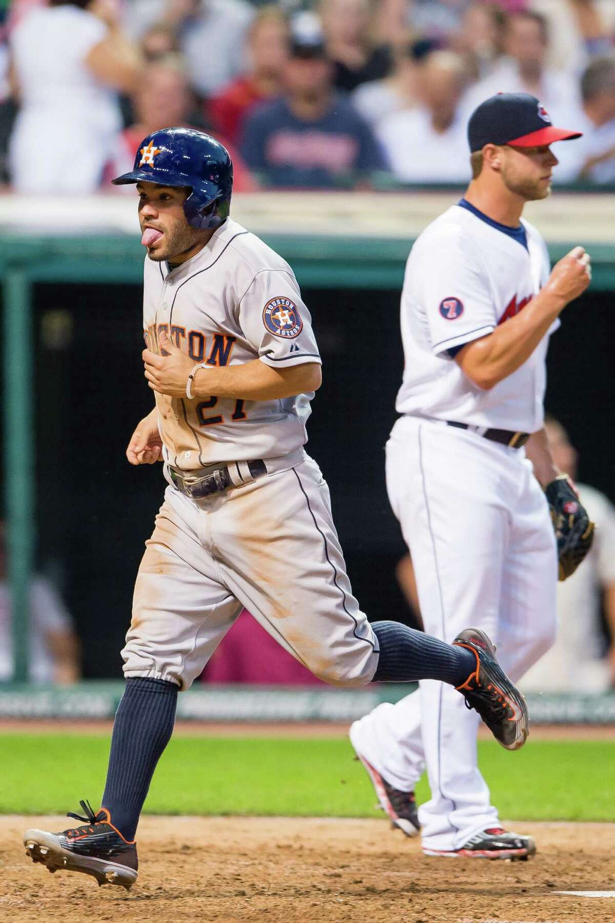 Astros second baseman Jose Altuve feels the effects of chugging around the bases to score on a single by Preston Tucker in the sixth inning.