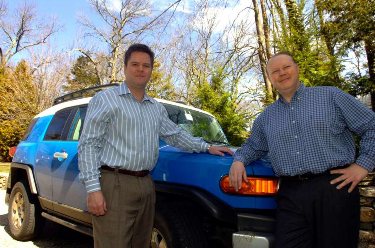 Scott Scanlon and Christopher Hunt rescued a family when they had a tree fall on the SUV on Saturday afternoon on the Merrit during the storm. They stand by the car they were diving on that occasion, at their home at 19 Stanwich Lane, in Greenwich, on Tuesday, March 16, 2010.