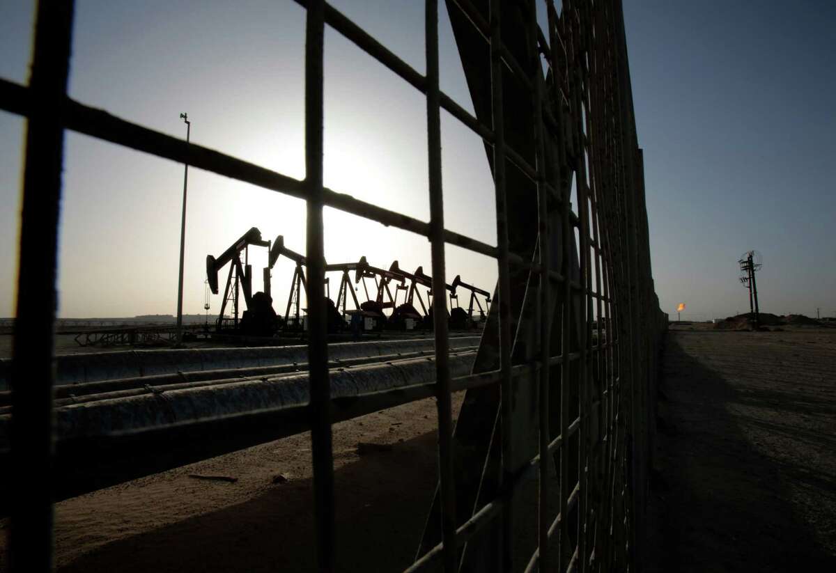 FILE - In this May 28, 2015 file photo, oil pumps work in the desert oil fields of Sakhir, Bahrain. A slew of global economic and geopolitical factors are working to pummel the price of oil and set up U.S. drivers for very low gasoline prices later this year. (AP Photo/Hasan Jamali, File)
