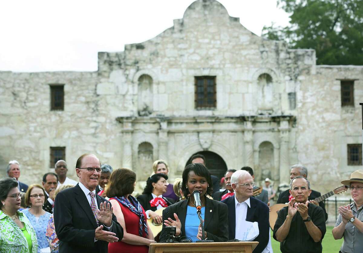 City leaders including Bexar County Nelson Wolff, left, and Mayor Ivy Taylor, center, celebrate the announcement of the San Antonio's Spanish missions winning World Heritage Site status on Tuesday, July 7, 2015 in front of The Alamo.