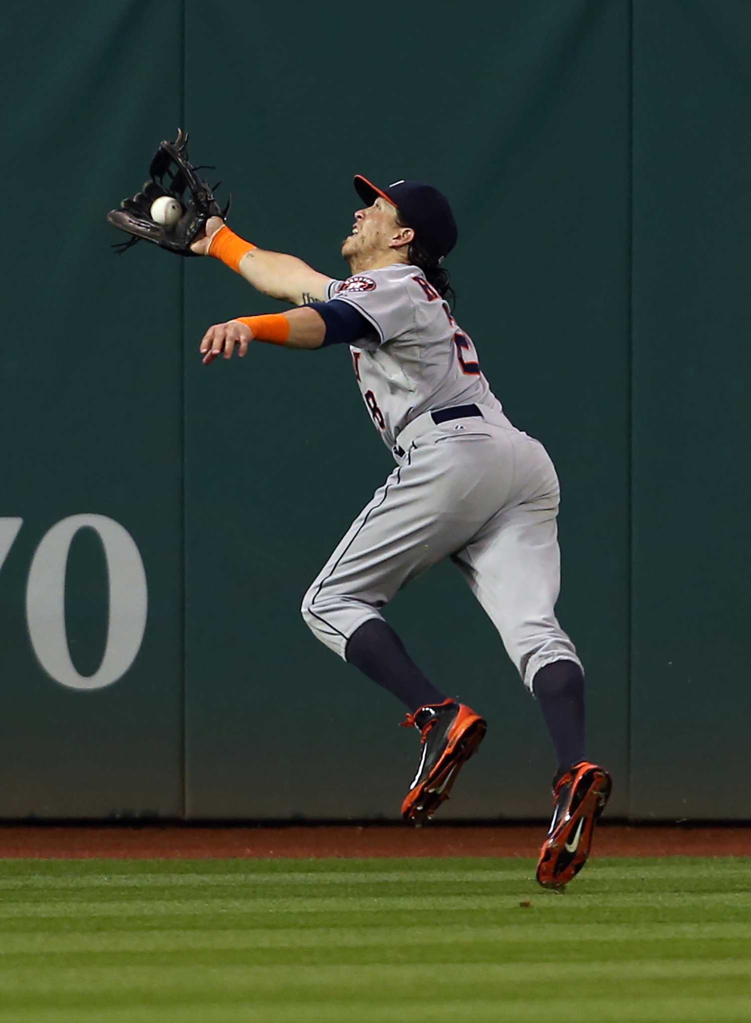 Houston Astros center fielder Michael Bourn catches a fly ball on
