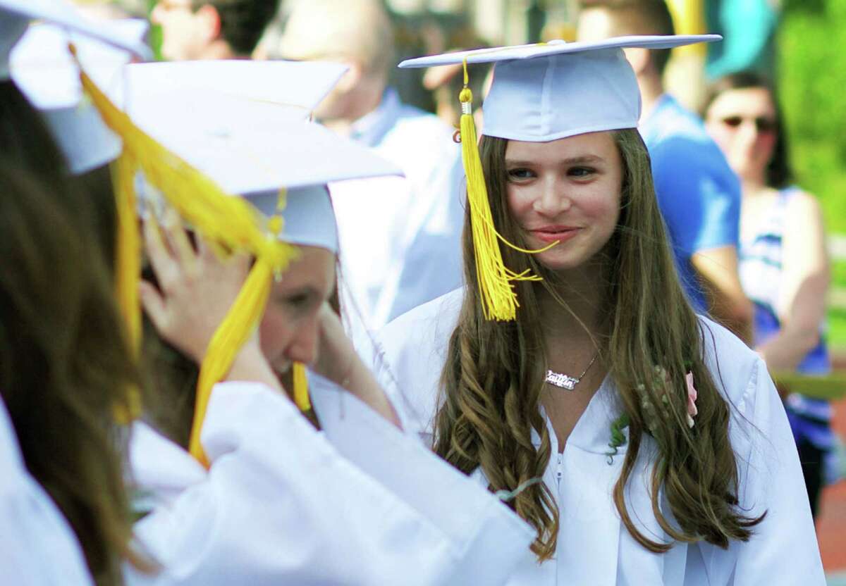 Caitlin Jellen beams as she takes her place amongst her classmates during Sherman School's eighth-grade graduation ceremony, June 19, 2015