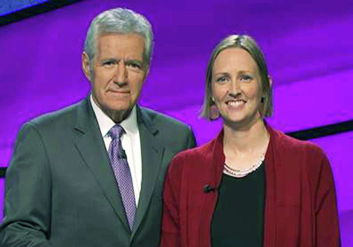Jessica Lindoerfer, a New Milford High School graduate, poses with longtime Jeopardy TV game show host Alex Trebek during her successful appearance on the show. July 2015