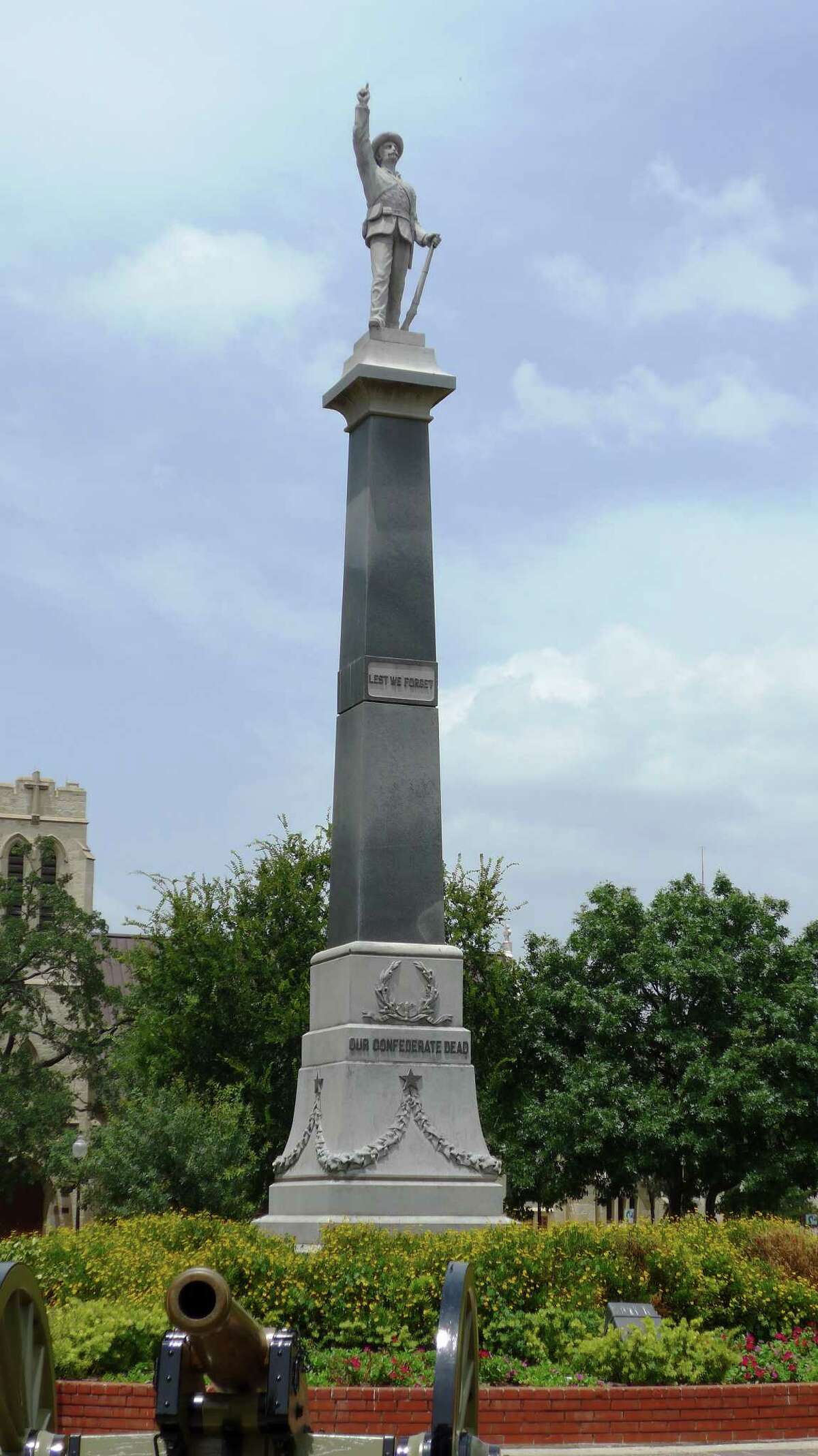 A monument to Confederate war dead, erected in city-owned Travis Park in 1899, says "Lest We Forget" and "Our Confederate Dead." Shown Wednesday, July 8, 2015.