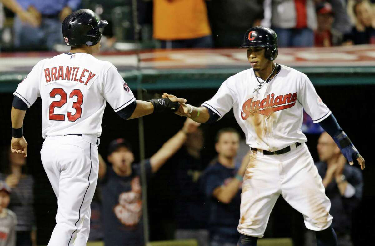 The Indians' Michael Brantley, left, and Francisco Lindor scored the decisive runs on David Murphy's double off Joe Thatcher.