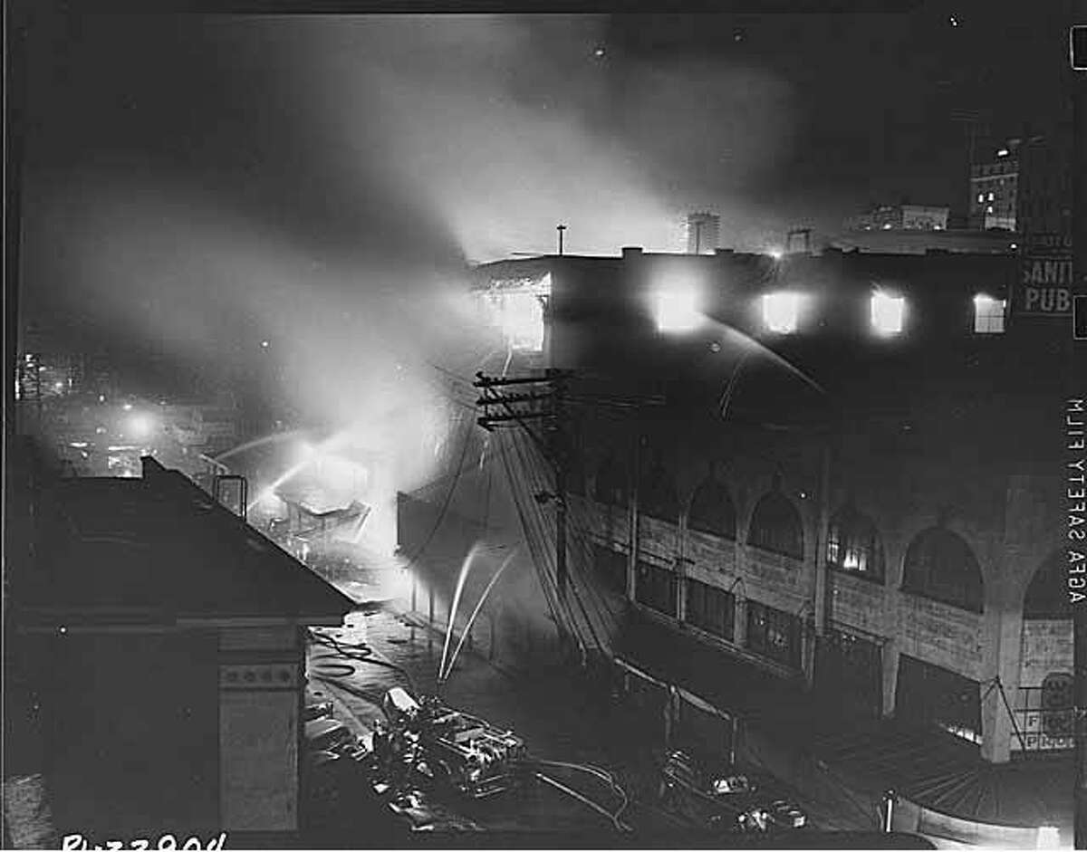 Firefighters battle a fire at the Corner Market Building near Pike Place Market on Dec. 15, 1941.