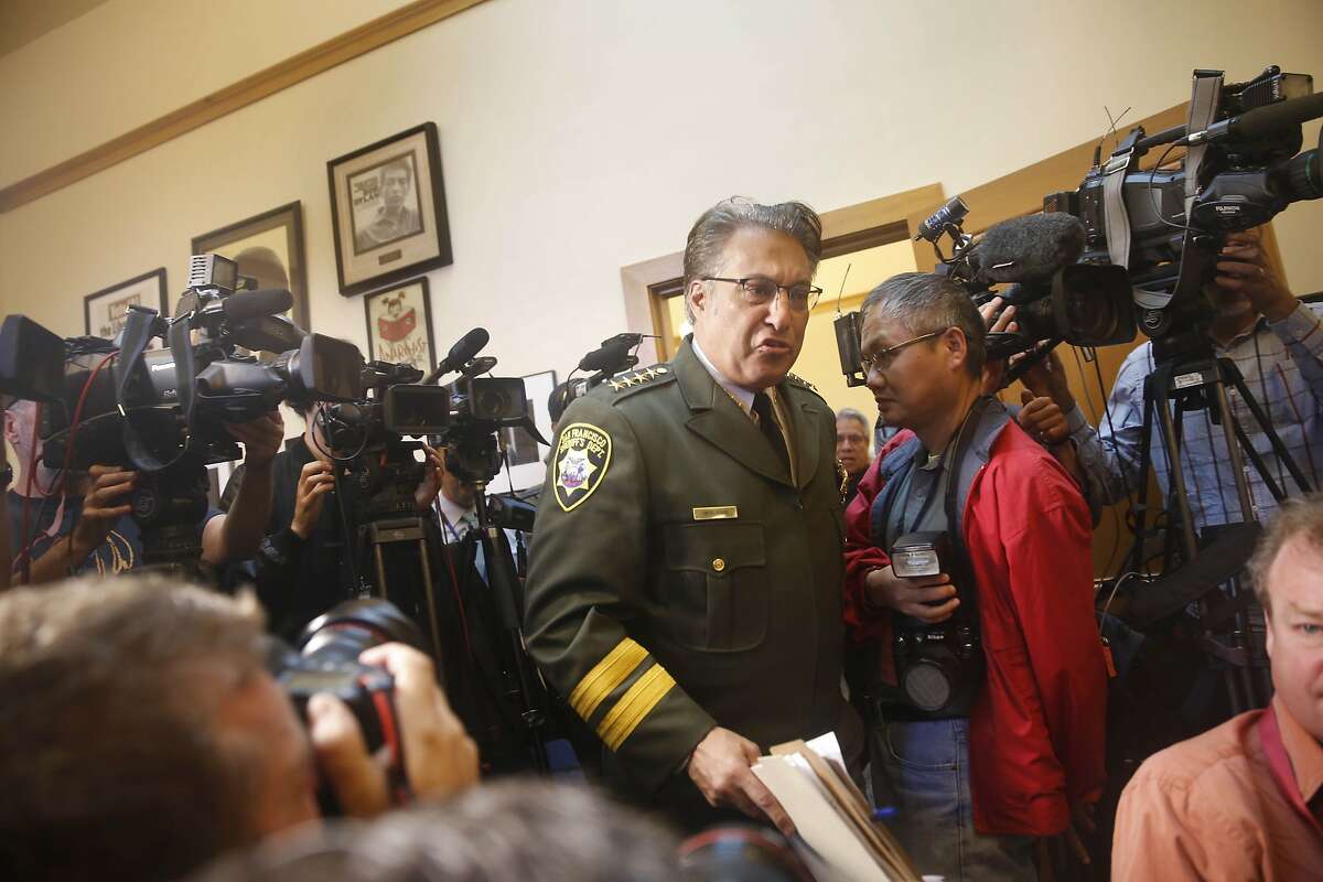 Sheriff Ross Mirkarimi arrives walks through a line of cameras as he arrives at a news conference at San Francisco City Hall on Friday, July 10, 2015 in San Francisco, Calif.