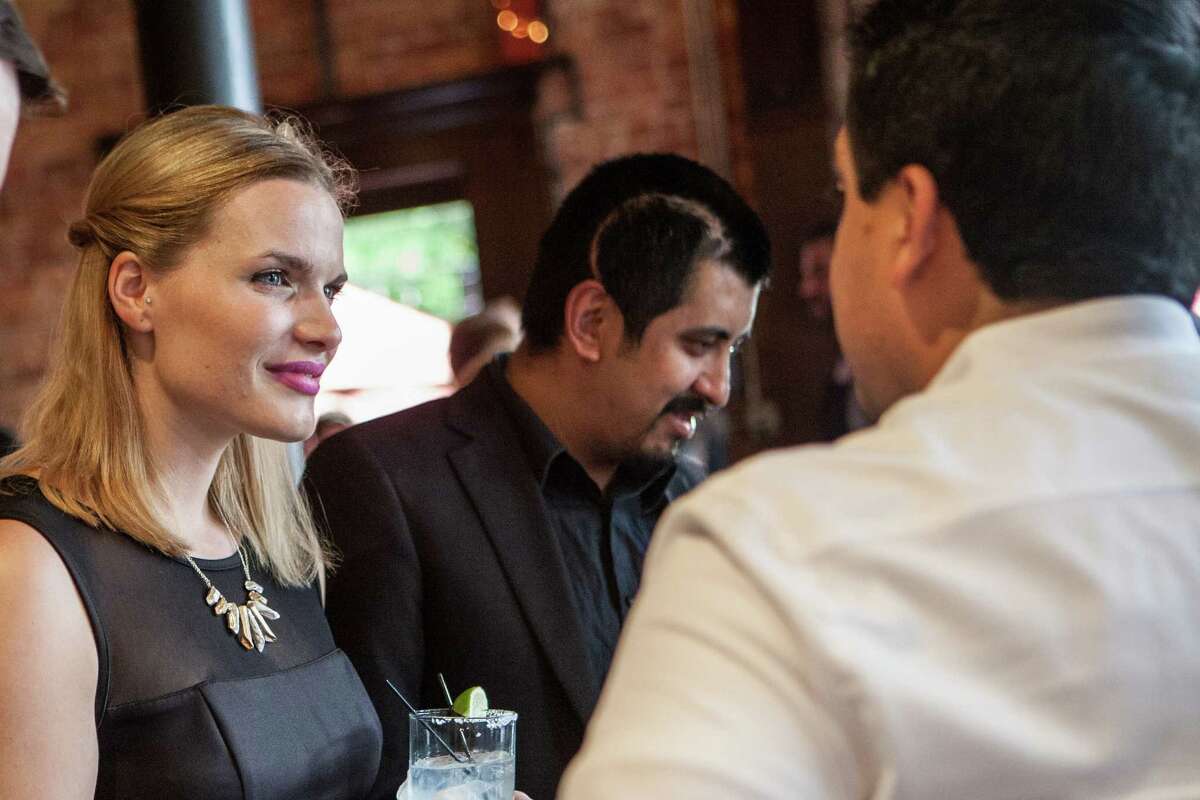 Gillian Givens and her husband, David Guerrero, talk to guests at a fundraiser at Batanga restuarant. Guerrero had recently undergone surgery to remove a second brain tumor, and the fundraiser was being held for him.
