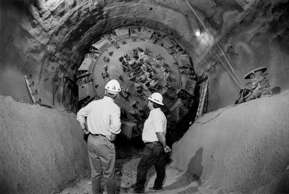 Army Corps of Engineers officials survey the giant boring device that drilled through earth 150 feet below the surface in 1991. The San Antonio River Tunnel was completed in 1997.
