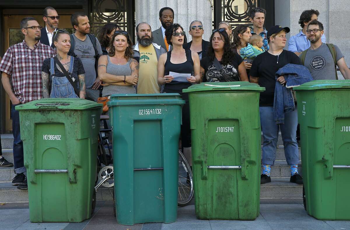 Gail Lillian, center, owner of Liba Falafel, gathered local restaurant owners and their compost bins on the the steps of City Hall in Oakland, Calif., to protest the increase of fees for compost and garbage pick up service as seen on Fri. July 10, 2015.