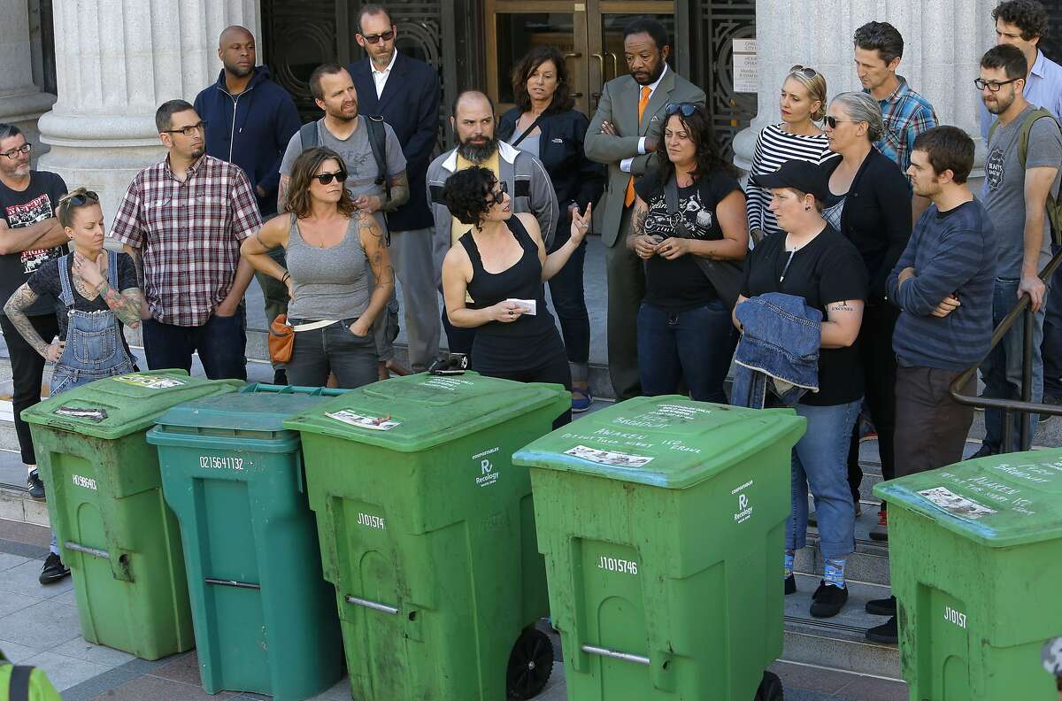 Gail Lillian, center owner of Liba Falafel gathered local restaurant owners and their compost bins on the the steps of City Hall in Oakland, Calif., to protest the increase of fees for compost and garbage pick up service as seen on Fri. July 10, 2015.